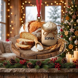 May include: A clear acrylic ornament featuring a printed image of a round loaf of bread, three bread slices, a wooden scoop, and a glass jar labeled 'SOPHIA' filled with white flour, all resting on a wooden board with wheat stalks.