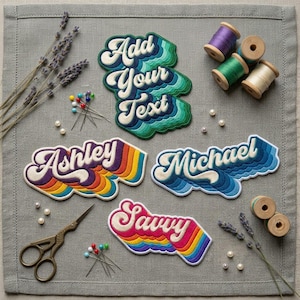 May include: Four embroidered patches with retro typography reading Add Your Text, Ashley, Michael, and Savvy. The patches feature layered, wavy color gradients. Included are sewing scissors, spools of thread, straight pins, and dried lavender.