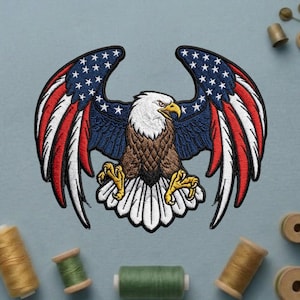 May include: A white ceramic mug with a black handle and the text "But First, Coffee" in a bold, black font. The mug is set against a blurred background, suggesting a cozy setting.