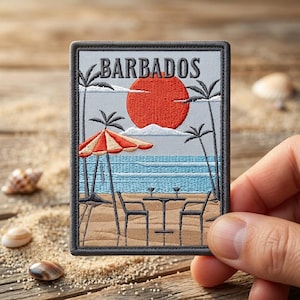 May include: A rectangular embroidered patch featuring the word BARBADOS in black text above a red sun, palm trees, a beach umbrella, and a table with two chairs on a sandy beach with blue ocean waves in the background, all bordered in black.