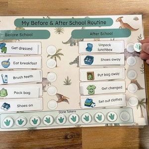 May include: A laminated dinosaur-themed chart titled My Before & After School Routine with two columns of tasks featuring icons and text. It includes circular spaces for tokens, a row labelled Done Tokens, and small circular tokens with green dinosaur footprints.