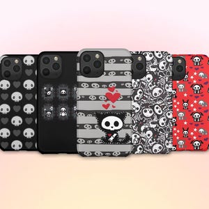 May include: A collection of five phone cases with unique designs. The cases feature patterns of skulls, hearts, and cartoon characters. Colors include black, white, gray, and red. The cases are designed for a smartphone.