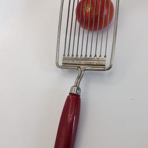 Vintage tomato slicer with serrated edges and wooden handle 1960s