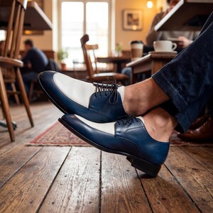 Two-tone men's footwear showing the leather lining and handmade stitching details.