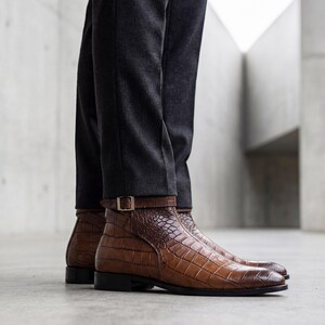 Side view of handmade brown alligator print boots showing the sleek Blake-stitch leather sole.