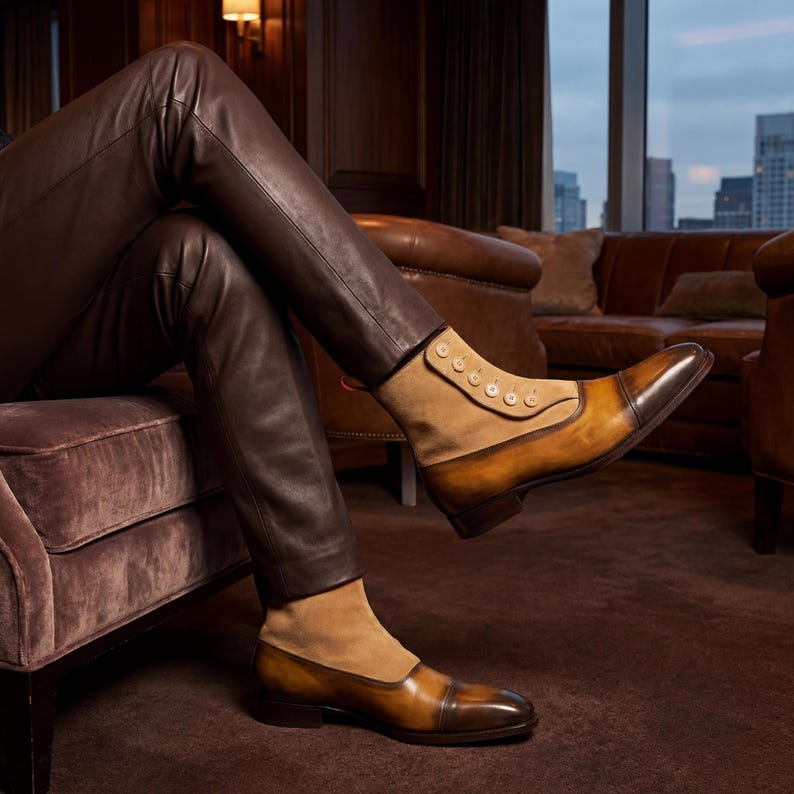 Mens handmade button boots in two-tone tan suede and burnished brown calfskin leather worn with leather pants.