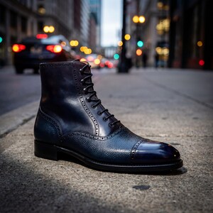 Close-up of pebble grain leather texture and brogue detailing on a blue lace-up boot.