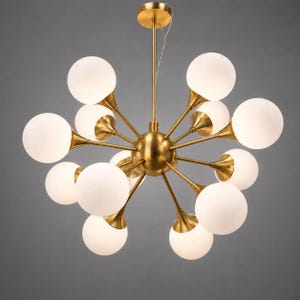 May include: A contemporary chandelier featuring a brass frame and numerous frosted glass globes. The light fitting has a central sphere with radiating arms, each supporting a globe. The design is symmetrical and stylish, ideal for interior lighting.