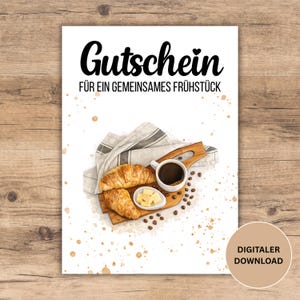 May include: A digital download gift certificate with the German text "Gutschein FÜR EIN GEMEINSAMES FRÜHSTÜCK" (Gift for a shared breakfast). The image shows a watercolour illustration of breakfast items: croissants, coffee, and butter.