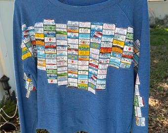 Travel upcycled sweatshirt features license plates