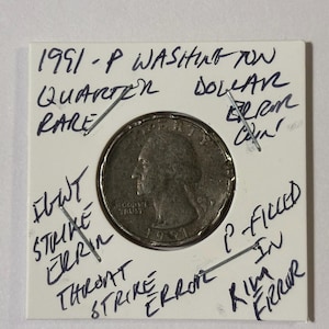 Könnte beinhalten: Eine seltene 1991-P Washington Quarter-Münze auf einer weißen Karte. Handschriftliche Notizen weisen auf Fehler hin: "Flaw Strike Error", "Throat Strike Error" und "Rim Error".