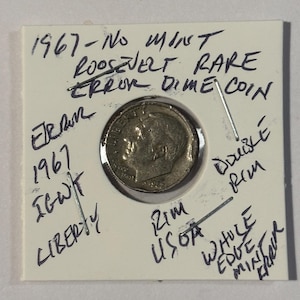 May include: A rare 1967 Roosevelt dime error coin. The coin is encased in a protective holder with handwritten notes indicating it is a rare error coin. The holder has the text "1967-No Mint Roosevelt Rare Error Dime Coin."