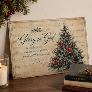 May include: A rectangular metal sign with a vintage-style beige background featuring musical notes, a decorated Christmas tree with red ornaments, and the text Glory to God in the highest, and on earth peace, good will toward men. Luke 2:14.