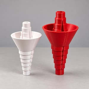 May include: A white and a red funnel, each featuring a stepped, tiered exterior design with a wide conical top section and a narrow, multi-layered base. These two plastic-like objects are positioned side-by-side, displaying a uniform vertical structure.