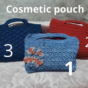 May include: Three handmade cosmetic pouches in the image. The text "Cosmetic pouch" is at the top. The pouches are in navy blue, red, and light blue. The light blue pouch has an orange and peach flower design. Each pouch has a handle.