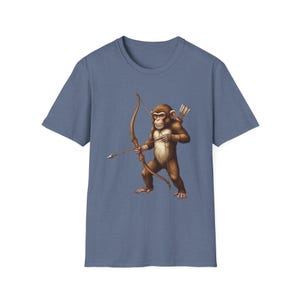 May include: A blue t-shirt featuring a detailed illustration of a monkey archer with a bow and arrow. The monkey is brown with a quiver of arrows on its back. The shirt is a solid, muted blue color.