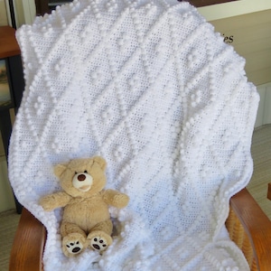 Modèle de couverture pour bébé au crochet avec losanges et pompons - Modèle de couverture pour bébé