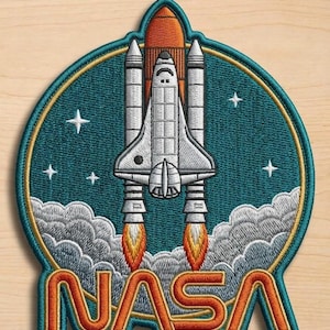 May include: Embroidered patch featuring a white space shuttle with orange boosters, emitting flames and smoke. The shuttle is set against a teal background with stars, encircled by a gold border. The word "NASA" is displayed in orange.