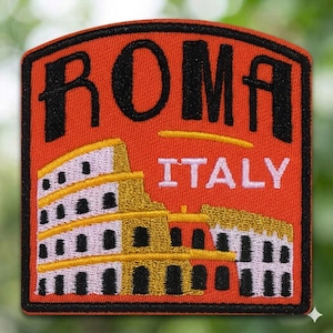 May include: Embroidered patch featuring the word "ROMA" in black, with "ITALY" below. The patch has an orange background and a black border. The design includes a depiction of the Colosseum in gold, white, and black.