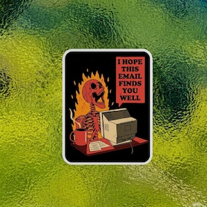 May include: A sticker featuring a skeleton in flames, working on a vintage computer. The skeleton has a red skull and is sitting at a desk with a mug and papers. Text reads: "I HOPE THIS EMAIL FINDS YOU WELL."