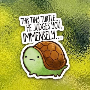May include: A sticker featuring a cartoon turtle with a green body and brown shell. The text on the sticker reads, "THIS TINY TURTLE... HE JUDGES YOU, IMMENSELY..."