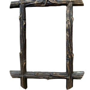 May include: A rectangular picture frame with a dark brown finish and gold highlights, featuring a textured surface that mimics the appearance of rough tree branches. The top center of the frame is decorated with a carved three-leaf motif.