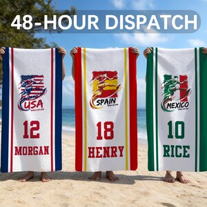 May include: Three rectangular beach towels featuring soccer-themed graphics. The left towel is blue and white with USA, 12, and MORGAN. The center towel is red, yellow, and white with SPAIN, 18, and HENRY. The right towel is green and white with MEXICO, 10, and RICE.