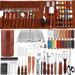 May include: A comprehensive leather crafting tool set. The image shows a brown leather tool roll filled with various tools, including punches, needles, scissors, and thread spools. The set includes a variety of tools for cutting, shaping, and stitching leather.
