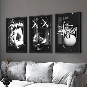 May include: Three framed wall art pieces with a black background. The art features a playing card, the letters XX, and an 8-ball, all in a glossy, 3D style. The Stussy logo is visible on two of the pieces.