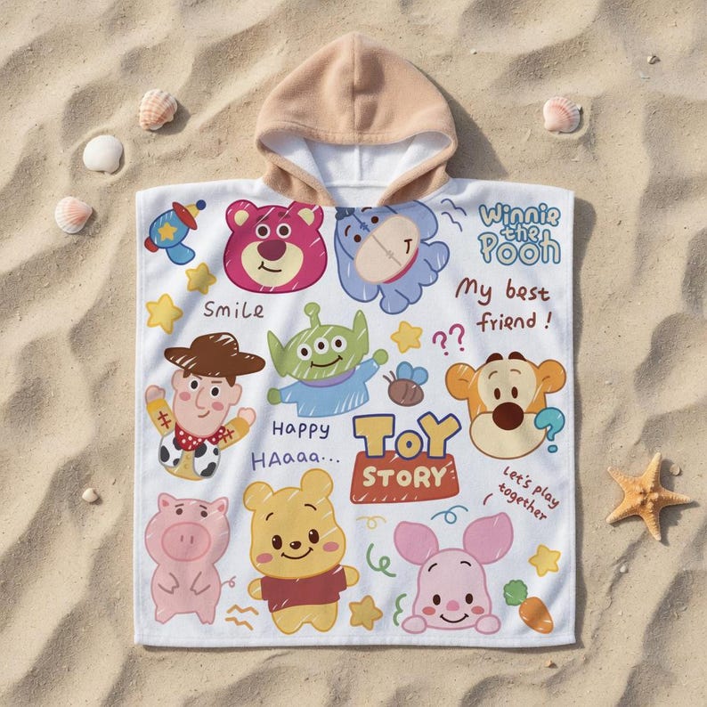 May include: White hooded beach towel featuring colorful cartoon characters from Toy Story and Winnie the Pooh. The towel includes the text "Smile", "Happy", "Toy Story", and "My best friend!". The hood is tan.