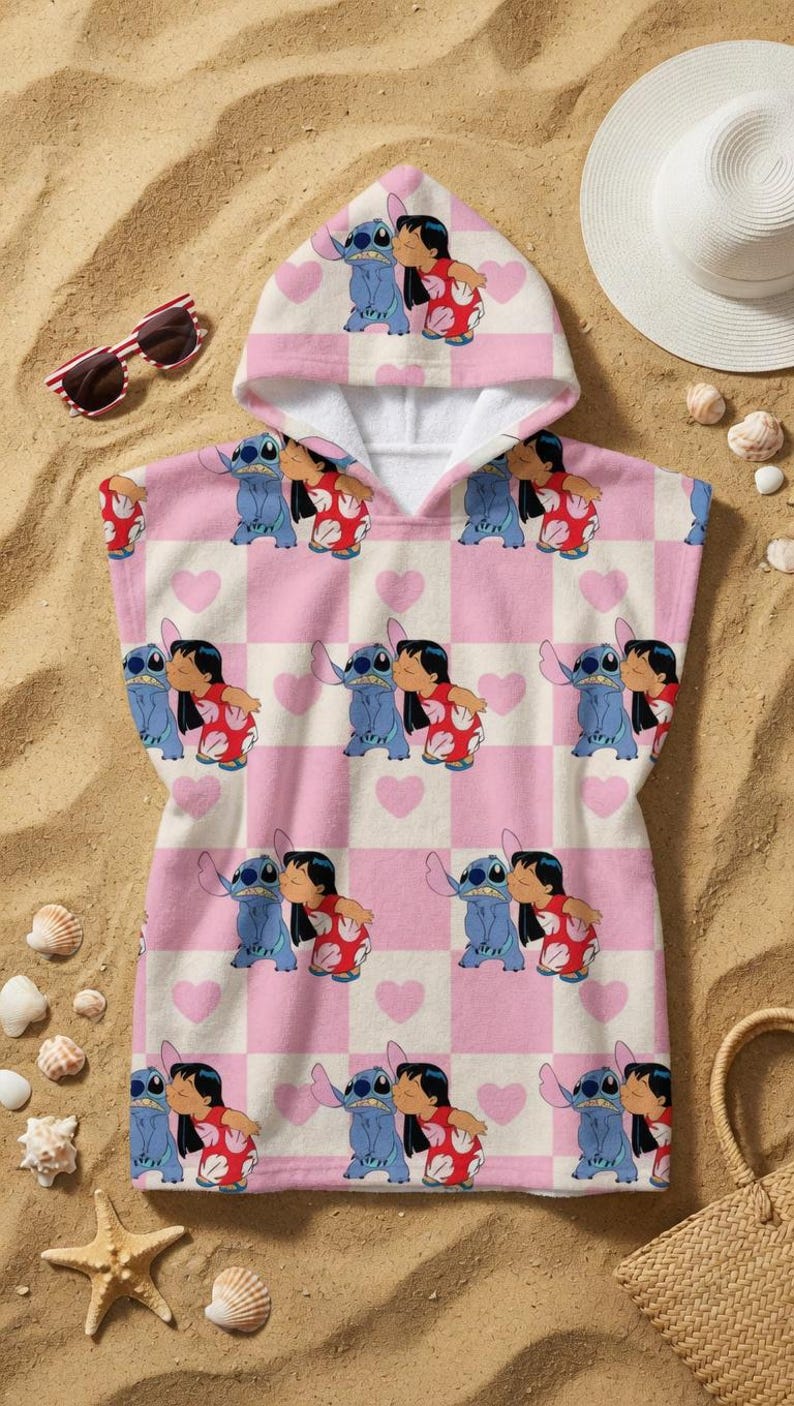 May include: A hooded poncho towel featuring a repeating pattern of Lilo and Stitch characters on a light pink and white checkered background with small pink hearts. The design shows the blue alien and the girl in a red floral dress kissing.