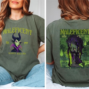 May include: Olive green t-shirt with the word "Maleficent" and a graphic of the Disney villain. The front also shows "Est. 1957" and "Disney Villain". The back of the shirt has a larger graphic of Maleficent with text.