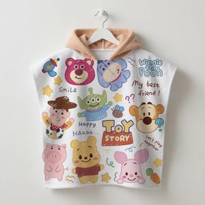 May include: White hooded towel featuring various Toy Story and Winnie the Pooh characters. The towel has a tan hood and is decorated with cartoon images of Woody, Buzz Lightyear, Piglet, and Pooh Bear. Text includes "Toy Story" and "My best friend!"