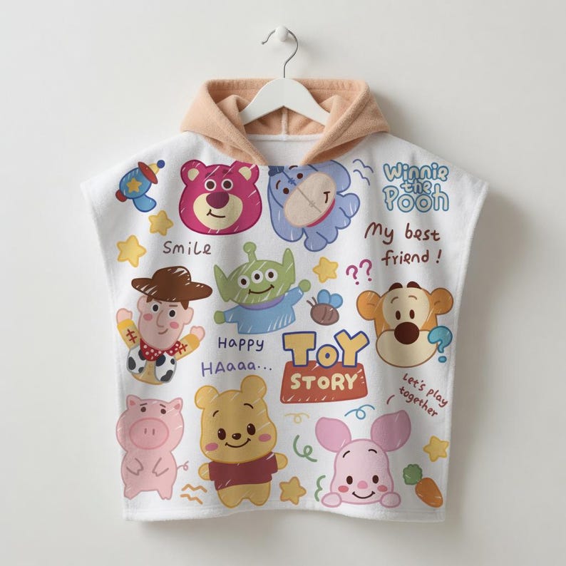 May include: White hooded towel featuring various Toy Story and Winnie the Pooh characters. The towel has a tan hood and is decorated with cartoon images of Woody, Buzz Lightyear, Piglet, and Pooh Bear. Text includes "Toy Story" and "My best friend!"