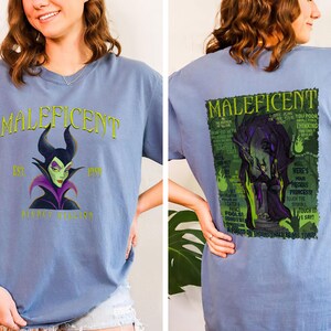 May include: A pale blue t-shirt with the word "Maleficent" in green, and an image of the character. The front of the shirt has the text "Est. 1959 Disney Villains". The back of the shirt has a graphic of Maleficent with text.