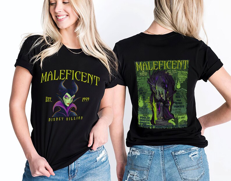 May include: Black t-shirts with a Maleficent design. The front displays "Maleficent", the year "1959", and a portrait of the character. The back features a green and black graphic. The shirts are worn by a person.