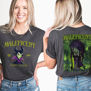May include: Dark grey t-shirt featuring the Disney villain Maleficent. The front of the shirt displays "Maleficent" in yellow text, with "Est. 1959" and "Disney Villain" below. The back features a green and purple graphic of Maleficent with text.