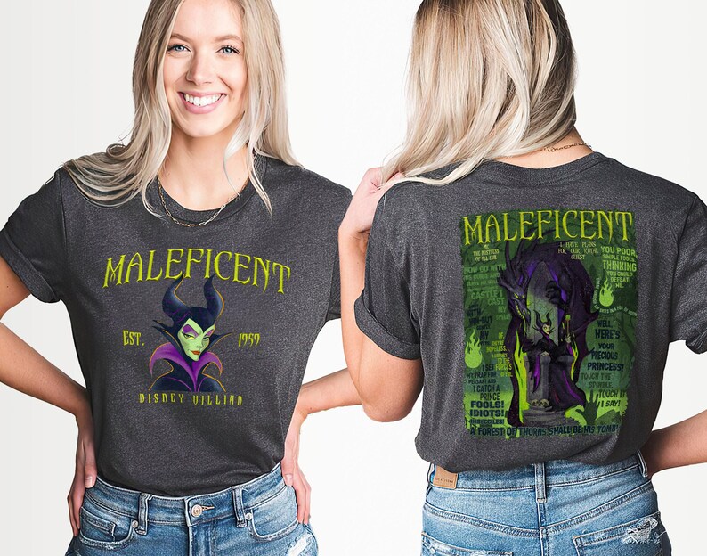 May include: Dark grey t-shirt featuring the Disney villain Maleficent. The front of the shirt displays "Maleficent" in yellow text, with "Est. 1959" and "Disney Villain" below. The back features a green and purple graphic of Maleficent with text.