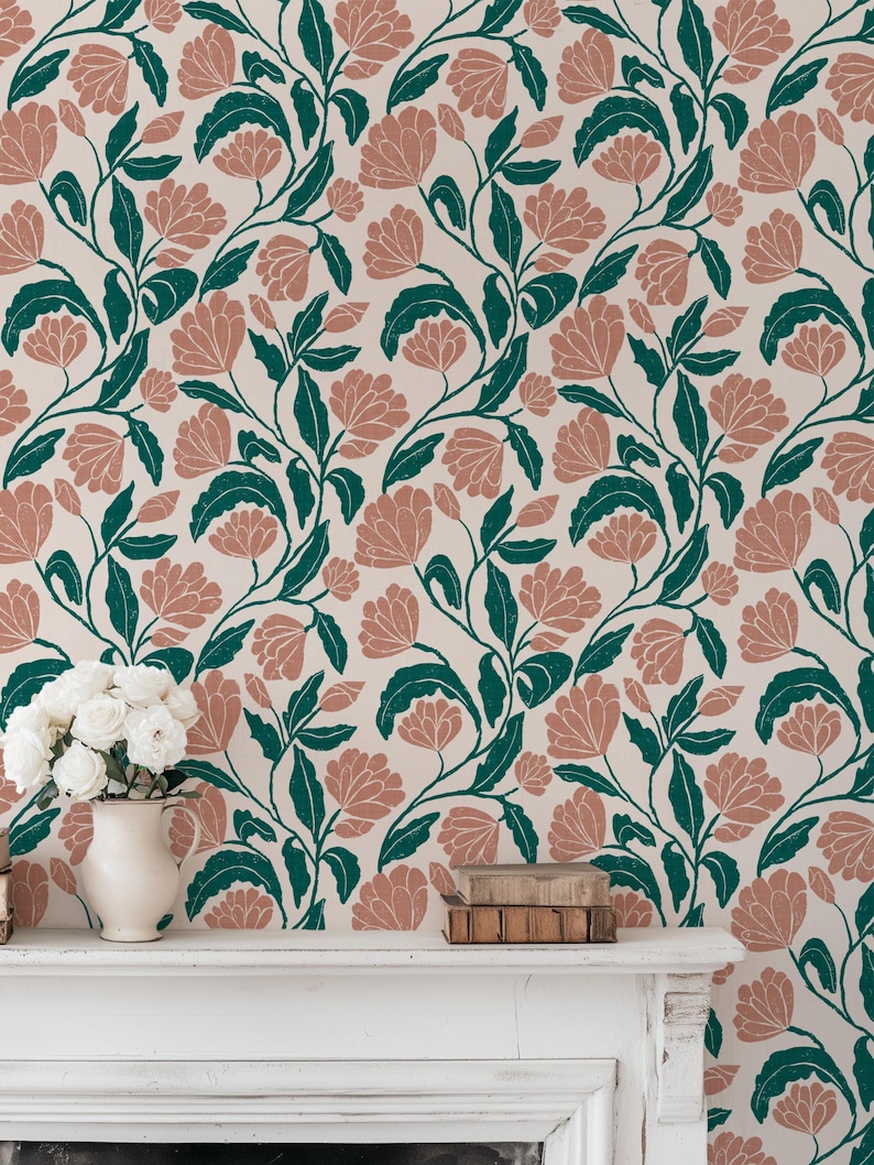 May include: Floral wallpaper featuring a repeating pattern of stylized pink flowers and dark green leaves on a cream background. The design has a vintage aesthetic, suitable for home decor. A white vase with white flowers and books are on a white mantel.