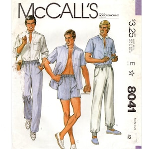 May include: A vintage McCall's sewing pattern for men's clothing, featuring three illustrations of men wearing different styles of pants and shirts. The pattern number is E 8041, and the size is 42. The price is $3.25.
