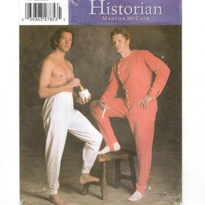 May include: Simplicity pattern 5033, "The Fashion Historian" by Martha McCain. The pattern features two men modeling historical clothing. One wears white pants, the other a red jumpsuit. The pattern size is AA, with measurements in inches.