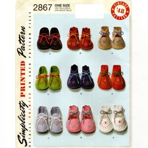 May include: A vintage Simplicity pattern featuring baby booties in various colors, including black, red, green, purple, pink, and white. Each pair has decorative stitching and ribbon ties. The pattern number is 2867, and it is a one-size design.