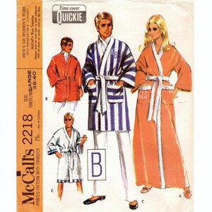 May include: A sewing pattern for a robe with a blue and white striped design, a solid orange robe, and a white robe. The pattern is McCall's 2218 and is for a chest size of 38-40 inches. The pattern includes a transfer for three letters.
