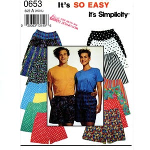 May include: Simplicity sewing pattern 0653 for elastic-waist shorts in size A (XXS-XL). The cover features various fabric designs including polka dots, stripes, floral, and geometric prints, alongside a photo of two individuals wearing shorts.