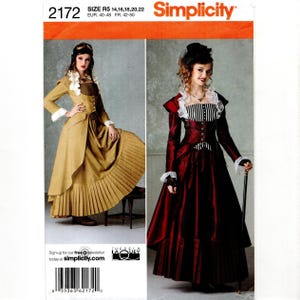 May include: A Simplicity sewing pattern envelope 2172 featuring two long-sleeved dresses with pleated skirts, ruffled collars, and fitted bodices. One dress is tan with a brown bodice, the other is dark red with a black and white striped bodice.