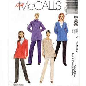May include: McCall's 2488 sewing pattern envelope featuring illustrations of four outfits. Designs include a red tunic with a kangaroo pocket, a purple turtleneck tunic, a beige patterned tunic, and a blue V-neck tunic, all paired with straight-leg pants.