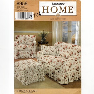 May include: A Simplicity Home pattern featuring easy slipcovers. The image showcases a floral-patterned sofa, armchair, and ottoman. The slipcovers have a cream background with red and pink floral designs. The pattern includes the text "8958" and "ONE SIZE".