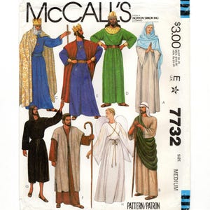 May include: McCall's sewing pattern featuring illustrations of religious figures in various robes and costumes. The pattern includes images of kings, angels, and other characters, with the number 7732 visible.