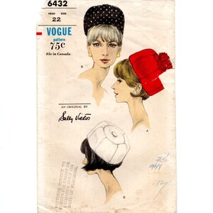 May include: A vintage Vogue sewing pattern envelope 6432 for hats, featuring illustrations of three styles: a black hat with white stars, a red hat with a pom-pom, and a white pillbox-style hat. The text includes Vogue, 6432, and Sally Victor.