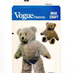May include: Vogue Patterns craft pattern envelope featuring a teddy bear design. The envelope is white with a blue top section and the Vogue Patterns logo. The pattern includes instructions to create a plush teddy bear.